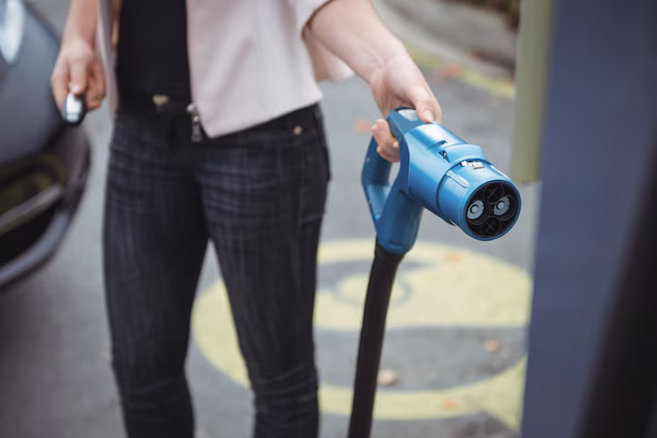 mid-section-woman-charging-electric-car_107420-94901